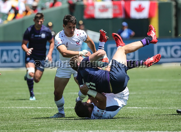 2018RugbySevensSun-02.JPG - United States player Stephen Tomasin pulls Scotland player Max McFarland (11) to the ground in the men's championship 5/8 place match in the 2018 Rugby World Cup Sevens, Sunday, July 22, 2018, at AT&T Park, San Francisco. USA defeated Scotland 28-0. (Spencer Allen/IOS via AP)